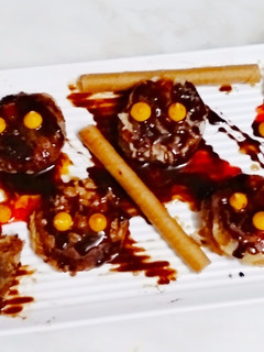 A picture of Chocolate cookies with chocolate sauce.