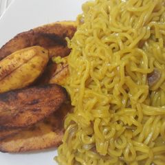 A picture of Curry noddles with fried plantain.