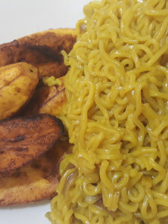 A picture of Curry noddles with fried plantain.