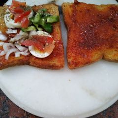 A picture of Schezwan egg sandwich.