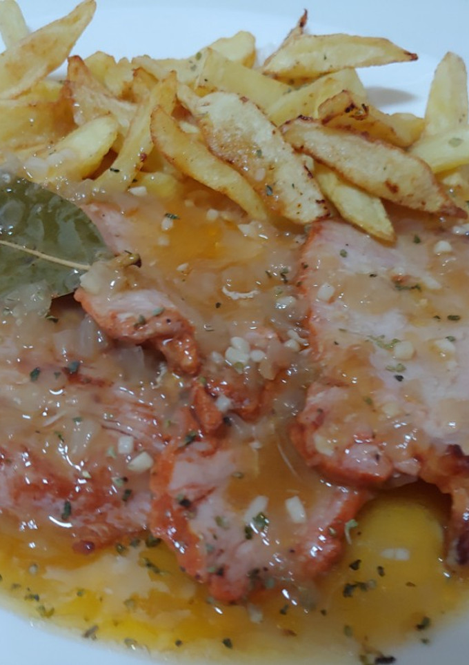 Una foto de Llom adobat amb ceba i amb salsa vi blanc. Lomo adobado en salsa de vino blanco