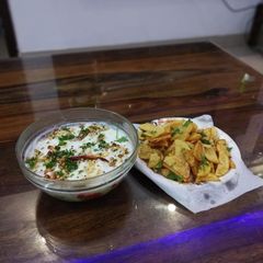 A picture of Curd rice and potato fries.