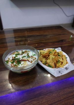 A picture of Curd rice and potato fries.