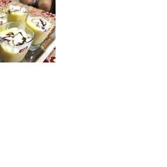 A picture of Mango shake with vanilla ice cream and some chocolate sauce.