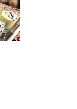 A picture of Mango shake with vanilla ice cream and some chocolate sauce.