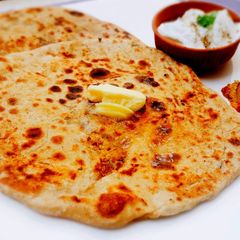 A picture of Aloo ka Paratha with Raw Potatoes.