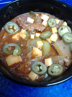 A picture of Bacon, sausage, and green tomato chili.