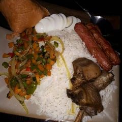 A picture of Boiled rice,fried chicken,sausages and stir fry vegetables.
