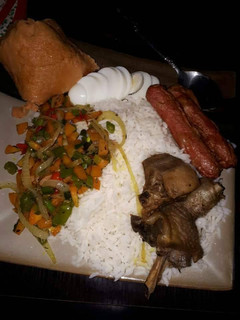 A picture of Boiled rice,fried chicken,sausages and stir fry vegetables.