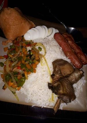 A picture of Boiled rice,fried chicken,sausages and stir fry vegetables.