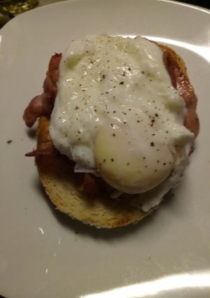 A picture of Pancetta and poached egg on toasted oregano bread.