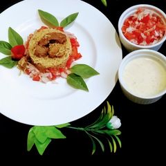A picture of Beef pulao with green chutney and kachmoar.