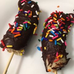 A picture of Kids treat frozen chocolate bananas 🍌.