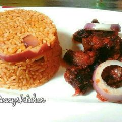 A picture of Jollof rice served with peppered beef.