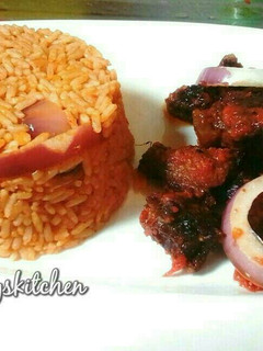 A picture of Jollof rice served with peppered beef.