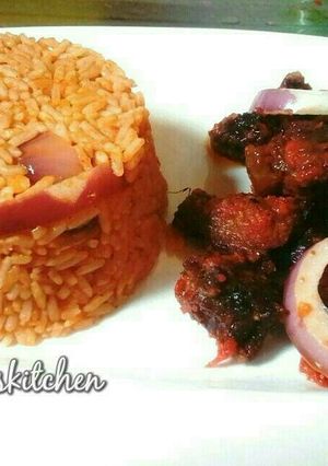 A picture of Jollof rice served with peppered beef.