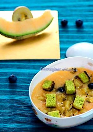 A picture of Muskmelon soup topped with green tea cake croutons.