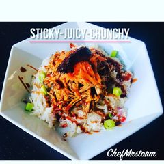 A picture of Pulled Pork with Lemon+Chilli Pepper+Red Onions Rice.Garnish-Salty Grated Carrots+Scallions.