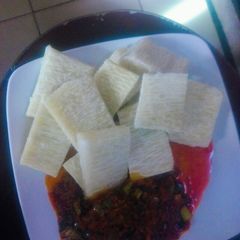 A picture of Yam and palm oil pepper sauce.