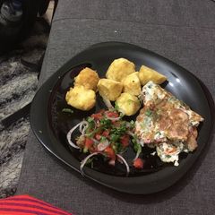 A picture of Deep fried potatoes, fried egg with kachumbari.
