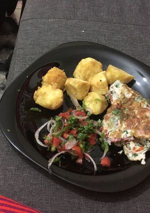 A picture of Deep fried potatoes, fried egg with kachumbari.