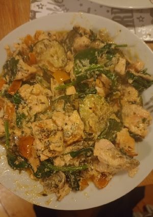 A picture of Salmon with courgettes spinach and orange bell pepper.