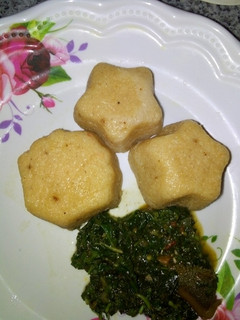 A picture of Moimoi with spinach sauce.