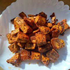 A picture of Baked tofu with spices and pickled white cabbage salad.