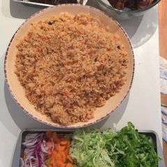A picture of Jollof Rice, goat meat & Turkey.