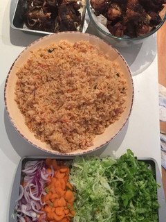 A picture of Jollof Rice, goat meat & Turkey.