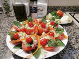 Pomodori ripieni di tonno, mozzarella e dadolata di cetrioli al profumo di basilico