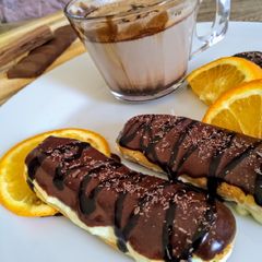 Choco orange eclair with fresh cream...cup of hot chocolate A picture of Choco orange eclair with fresh cream...cup of hot chocolate.