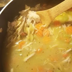 A picture of Chicken soup (with bones).