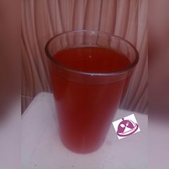 A picture of Lemon juice with mint leaf.