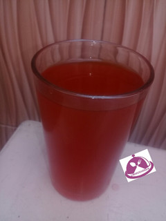 A picture of Lemon juice with mint leaf.