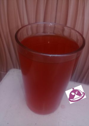 A picture of Lemon juice with mint leaf.