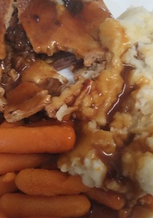 A picture of Gluten free steak pie with fluffy mash with carrots and gluten free gravy.