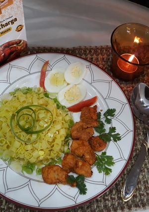 A picture of Macroni rice with charga bites.