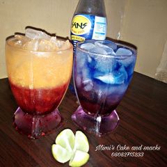 A picture of Sunrise moctail and layered blue paradise.