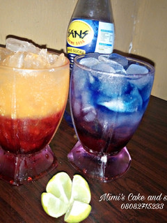 A picture of Sunrise moctail and layered blue paradise.
