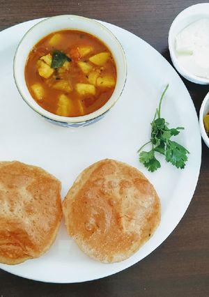 A picture of Masala kachori with aloo tamatar curry.