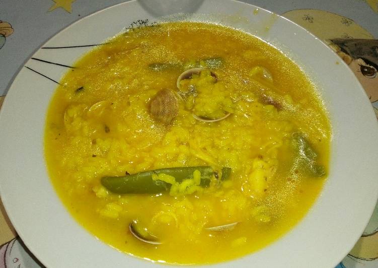 Arroz caldoso con caldo de pescado casero y chirlas