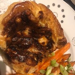 A picture of Goats Cheese Tart with caramelised onions, walnuts, black pepper and fresh basil.