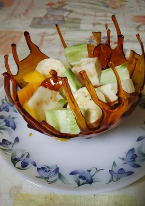 A picture of Caramel basket with fruit salad.