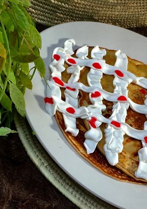A picture of Pancake with whipped cream.