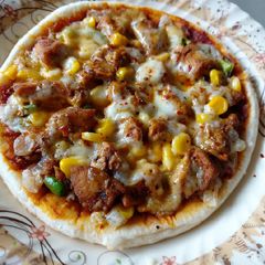 A picture of Chicken tikka pizza.