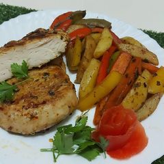A picture of Chicken Steak with stir fried Vegetables.