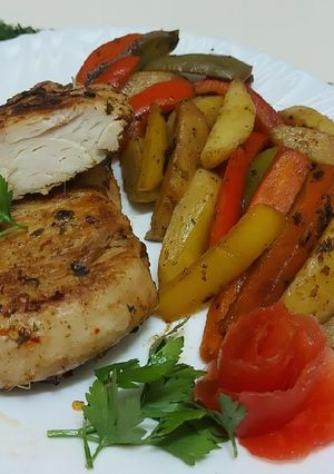 A picture of Chicken Steak with stir fried Vegetables.