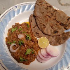 A picture of Mashed brinjals with bajra roti baingan ka bartha and bajre ki roti.