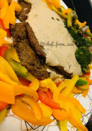 A picture of Butter Beef Steaks serve with pepper white sauce and stir fry veggies.